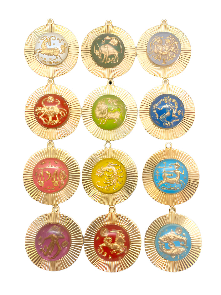 Collection of 12 vintage gold-plated zodiac sign pendants with colorful glass enamel designs arranged in a grid, featuring all astrological signs in red, green, blue, yellow, and pink backgrounds