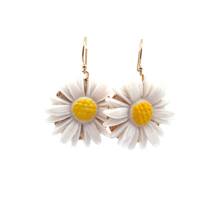 Daisy flower earrings with white petals and yellow centers on a white background