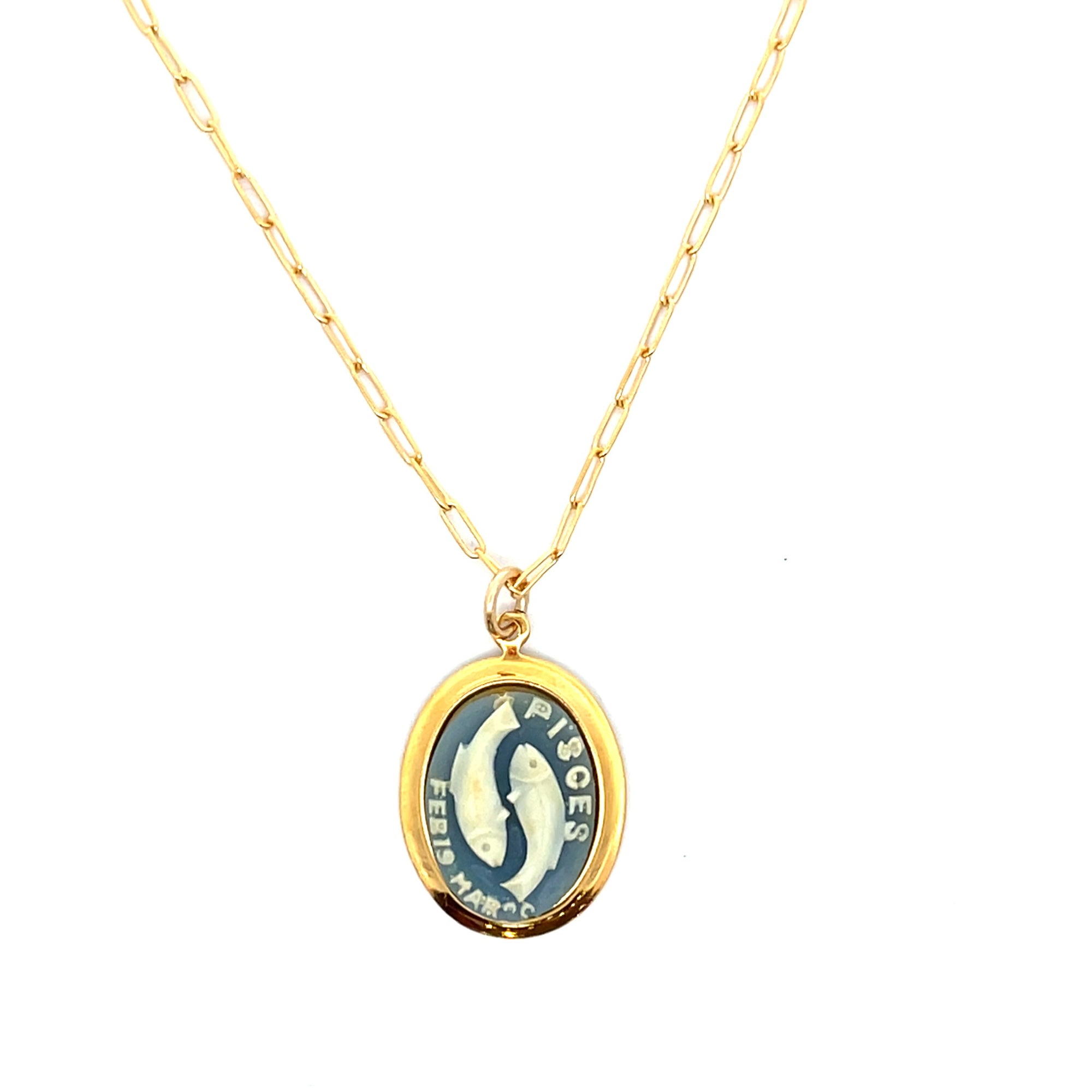 Gold necklace with a pendant featuring a fish illustration and text on a white background