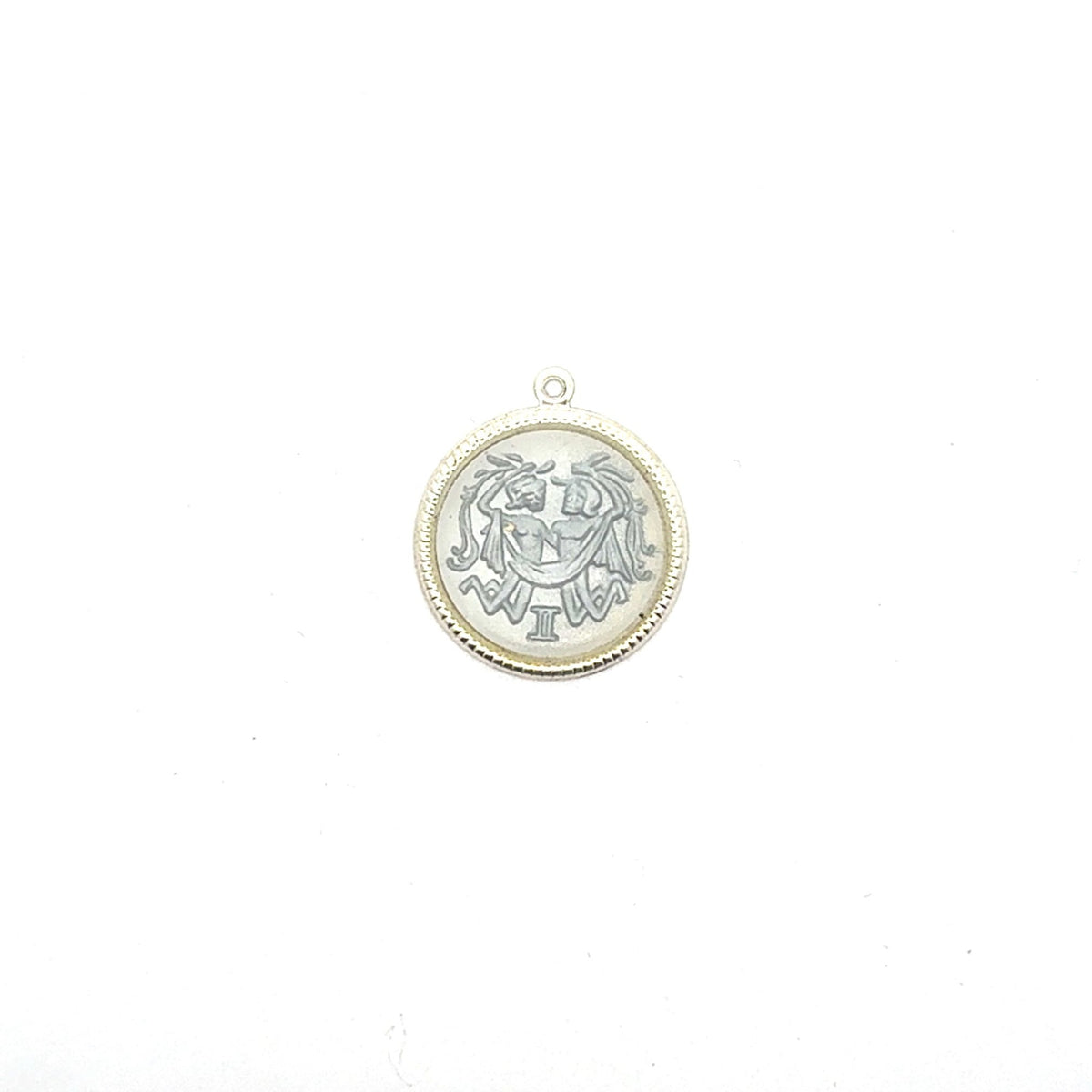 Silver round Gemini zodiac coin charm with twins design and Roman numeral II against a white background