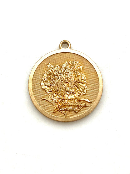 Gold embossed January carnation birth month flower coin pendant charm on a white background
