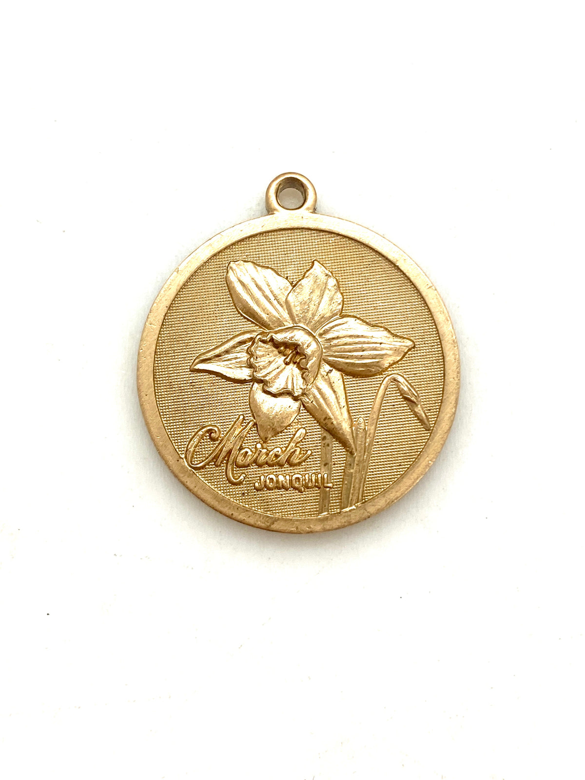 Gold embossed March jonquil birth month flower coin pendant charm on a white background