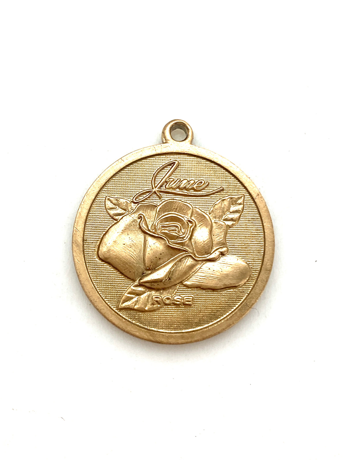 Gold embossed June rose birth month flower coin pendant charm on a white background