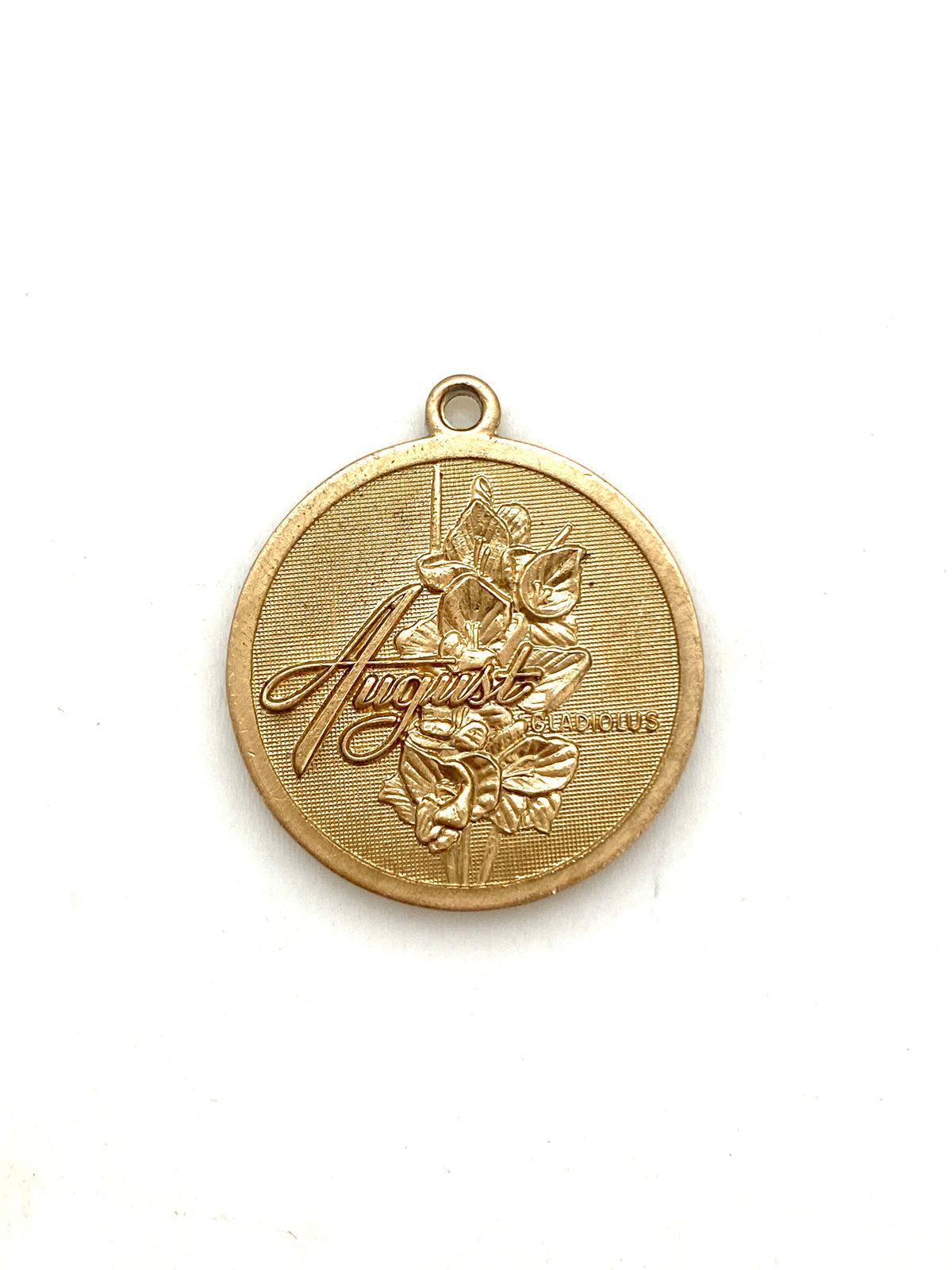 Gold embossed August gladiolus birth month flower coin pendant charm on a white background