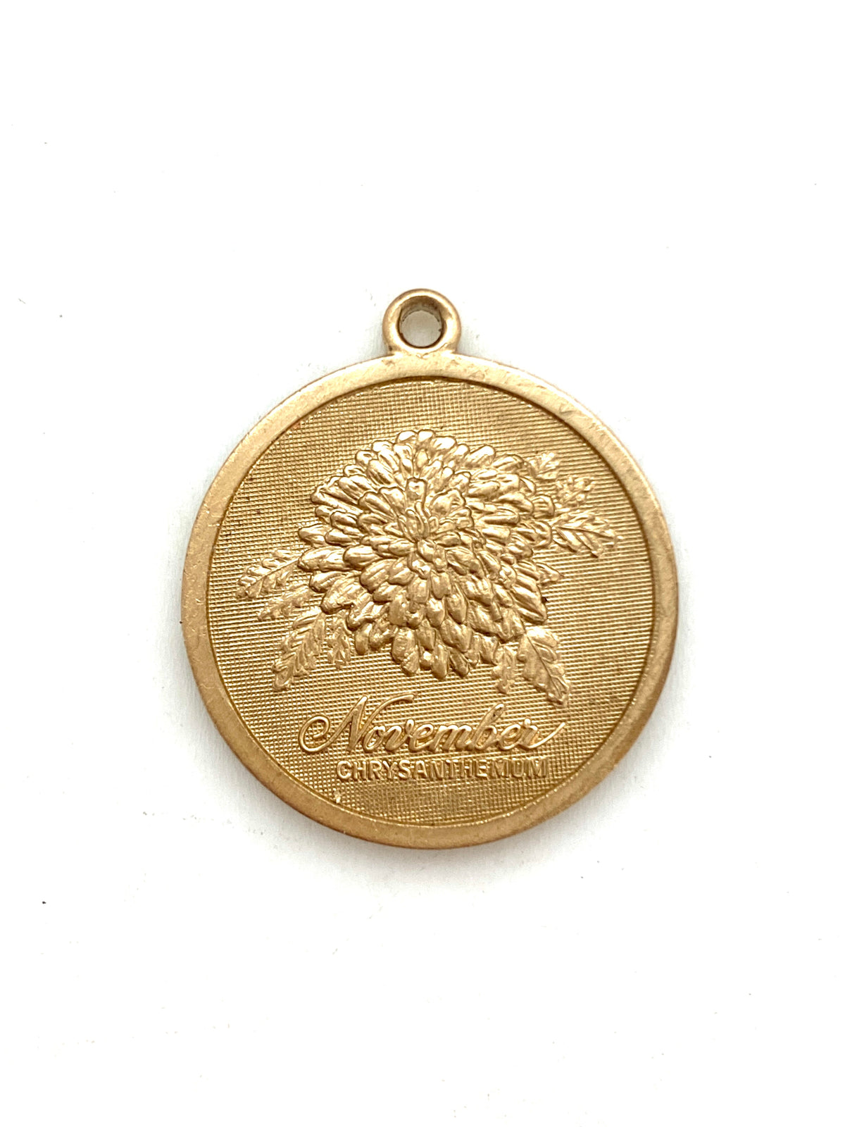 Gold embossed November chrysanthemum birth month flower coin pendant charm on a white background