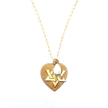 Full-length view of a gold ribbed heart pendant necklace with Star of David design and pearl accent on a gold paperclip chain against a white background