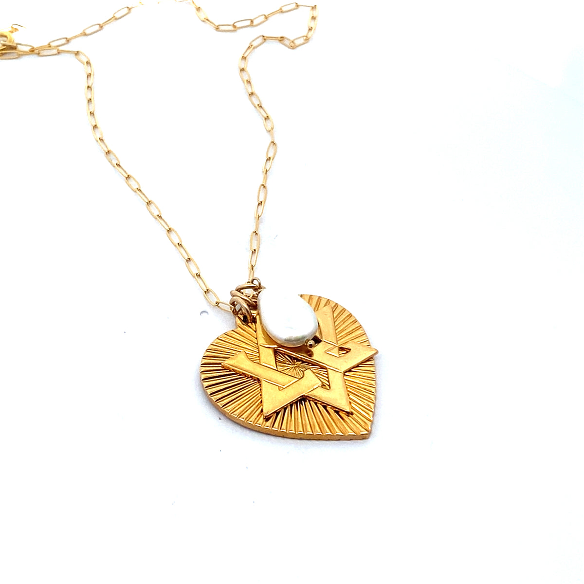 Angled view of a gold ribbed heart pendant with Star of David design and pearl moonstone accent on a gold paperclip chain against a white background