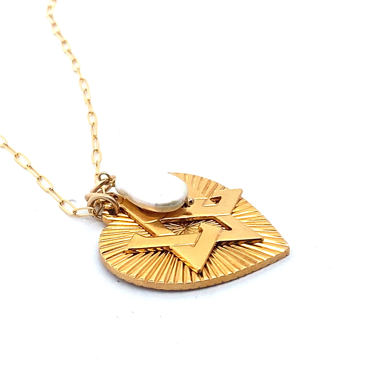 A gold-plated necklace featuring a ribbed heart with a Star of David charm and a large freshwater pearl pendant, displayed on a person's neck.