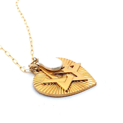 A gold-plated necklace featuring a ribbed heart with a Star of David charm and a large freshwater pearl pendant, displayed on a person's neck.