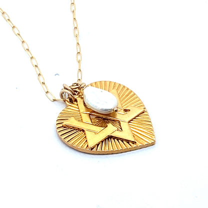 A gold-plated necklace featuring a ribbed heart with a Star of David charm and a large freshwater pearl pendant, displayed on a person's neck.
