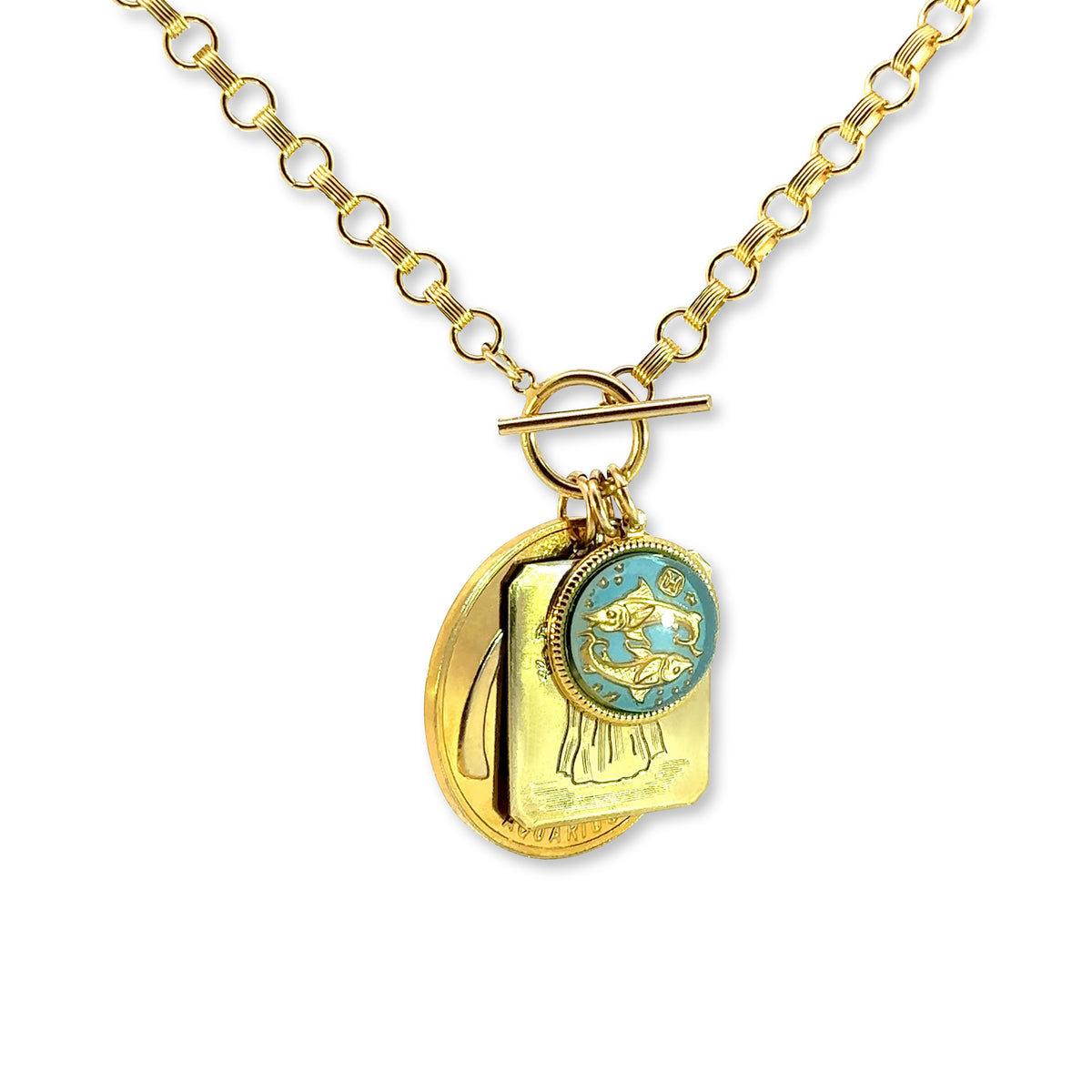 Gold rolo chain necklace with toggle clasp featuring layered charms including a light blue vintage glass Pisces fish intaglio cameo a gold Aquarius rectangular pendant and a gold birth month flower coin on a white background