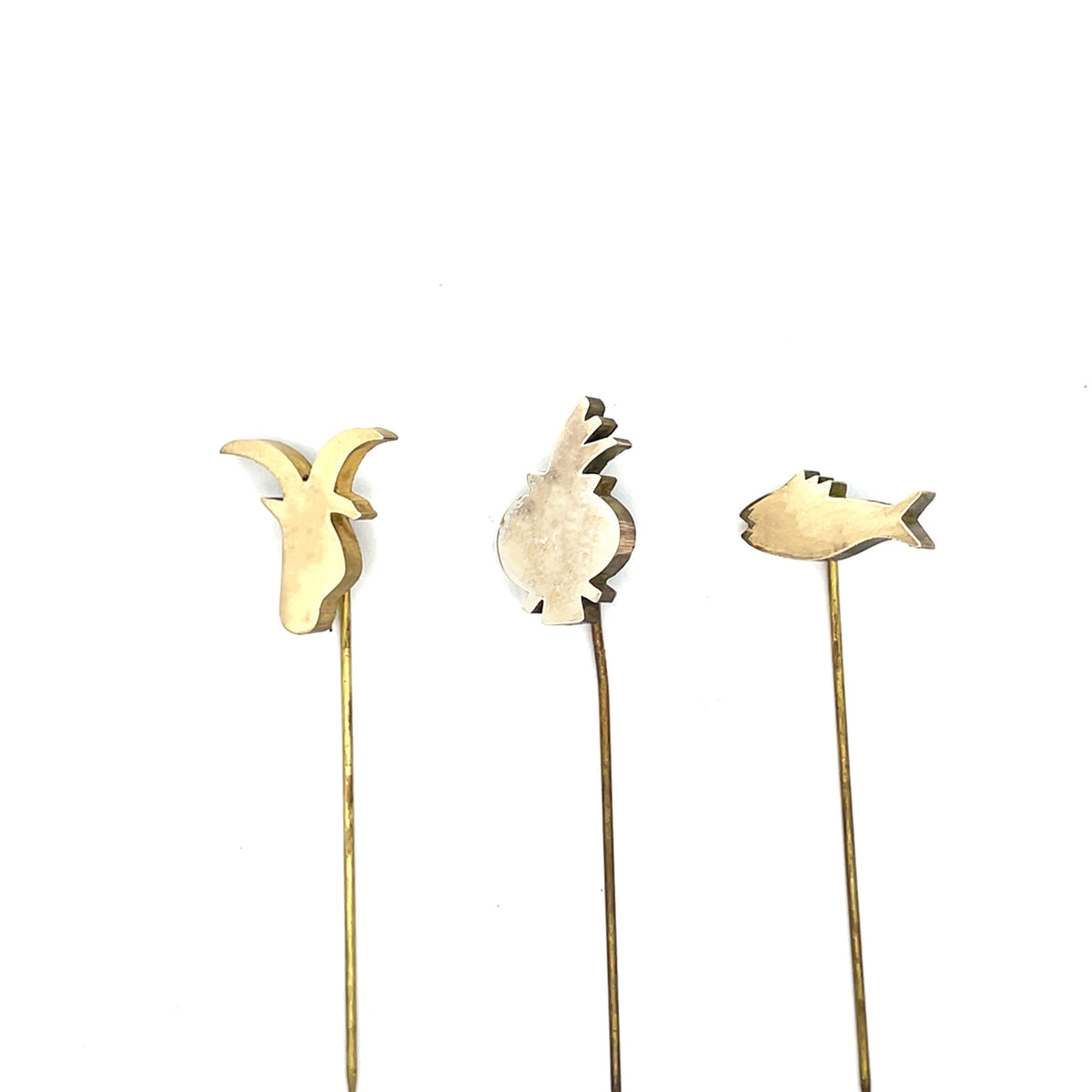 Three decorative garden stakes with pineapple, deer, and fish shapes on a white background