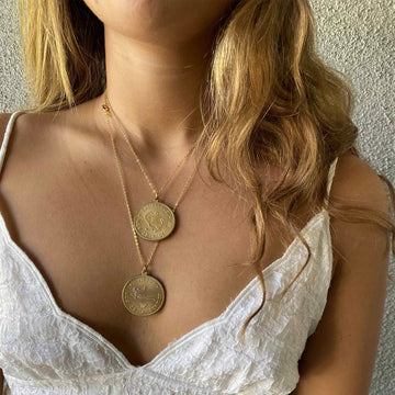 image of a women wearing a necklace with a virgo and Sagittarius vintage brass coin zodiac sign charm
