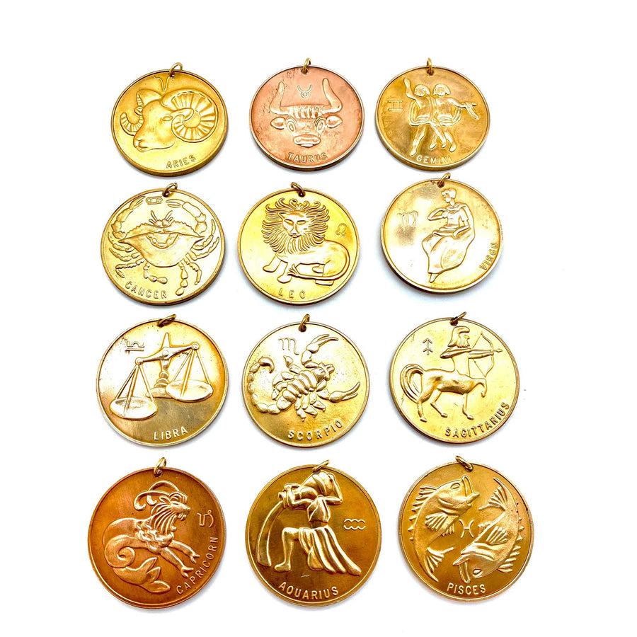 front view of extra large vintage coin zodiac sign charms